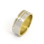 Edelstahlring, poliert, teilvergoldet mit 3 versetzten Zirkonia